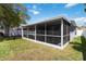 Relaxing screened porch with outdoor seating and views of the backyard at 16620 Fairbolt Way, Odessa, FL 33556