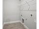 Efficient laundry room with tile floors and a wire shelf for added storage at 1724 Sunset Preserve Way, Port Charlotte, FL 33953