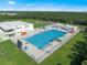 Aerial view of a community pool with ample seating and green spaces at 1724 Sunset Preserve Way, Port Charlotte, FL 33953