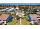 Aerial view showcasing the neighborhood's community pool and manicured green spaces at 1770 Lake Pl # 1770D, Venice, FL 34293