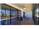 Relaxing screened balcony with tile flooring, ceiling fan, and sliding glass doors for enjoying the outdoors at 1770 Lake Pl # 1770D, Venice, FL 34293