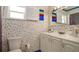Cozy bathroom featuring colorful wallpaper, a single sink vanity, a window with blinds, and a shower at 1770 Lake Pl # 1770D, Venice, FL 34293