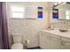 Charming bathroom with floral wallpaper, white vanity, and medicine cabinet over sink at 1770 Lake Pl # 1770D, Venice, FL 34293