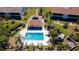 Aerial view of the community pool, surrounded by lounge chairs and lush landscaping at 1770 Lake Pl # 1770D, Venice, FL 34293