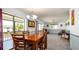 Elegant dining room with dark wood furniture, natural light and access to an outdoor terrace at 1770 Lake Pl # 1770D, Venice, FL 34293