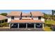 Inviting condominium featuring a covered parking area and meticulously maintained landscaping at 1770 Lake Pl # 1770D, Venice, FL 34293