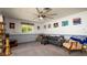Comfortable living room with a large ceiling fan, cozy seating, and a view of the outside at 1770 Lake Pl # 1770D, Venice, FL 34293