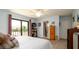 Spacious main bedroom with soft carpet, large windows, sliding glass door access, and a private bath at 1770 Lake Pl # 1770D, Venice, FL 34293