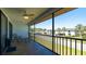 Relaxing screened patio featuring a ceiling fan, tile flooring, and comfortable lounge seating at 1770 Lake Pl # 1770D, Venice, FL 34293