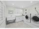 Well-lit laundry room equipped with washer, dryer, utility sink, and storage at 1928 Harbourside Dr # 1404, Longboat Key, FL 34228