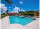 Inviting community pool with poolside seating and beautiful architectural details with tile roofing at 1928 Harbourside Dr # 1404, Longboat Key, FL 34228