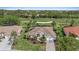 Aerial view of a landscaped home near a green golf course at 1975 White Feather Ln, Nokomis, FL 34275