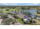 Community clubhouse with a large lake, well-maintained landscaping, and convenient parking at 1975 White Feather Ln, Nokomis, FL 34275