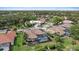 Aerial shot of a home with a screened pool in a lush, green neighborhood at 1975 White Feather Ln, Nokomis, FL 34275