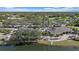 Community clubhouse surrounded by lush trees, parking and overlooking a scenic lake at 1975 White Feather Ln, Nokomis, FL 34275