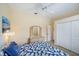 This bedroom features a ceiling fan, closet, beach-themed art, and a dresser with a matching mirror at 1975 White Feather Ln, Nokomis, FL 34275