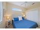 This bedroom showcases a ceiling fan, coastal-themed decor, and a large window, offering ample natural light at 1975 White Feather Ln, Nokomis, FL 34275