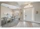 Dining room with a glass-topped dining table, stylish striped chairs, and a modern chandelier at 1975 White Feather Ln, Nokomis, FL 34275
