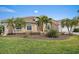Charming single-story home with a well-manicured lawn and lush tropical landscaping at 1975 White Feather Ln, Nokomis, FL 34275
