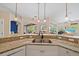 Kitchen sink area with granite countertops and breakfast bar with an open-concept design at 1975 White Feather Ln, Nokomis, FL 34275
