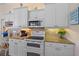 Close up on the oven and microwave in the bright kitchen with granite countertops and under cabinet lighting at 1975 White Feather Ln, Nokomis, FL 34275