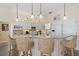 Kitchen with granite countertops, island seating, white cabinets, and adjacent laundry area at 1975 White Feather Ln, Nokomis, FL 34275