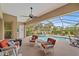 Screened lanai featuring a pool, spa, plenty of seating, and views of the manicured backyard at 1975 White Feather Ln, Nokomis, FL 34275
