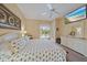 This is a bedroom featuring a ceiling fan, palm tree themed bedding, a television, and a view of the pool at 1975 White Feather Ln, Nokomis, FL 34275