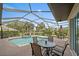 A well-kept pool and spa are set within a screened-in enclosure with golf course views at 1975 White Feather Ln, Nokomis, FL 34275
