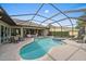 Screened pool area with a sparkling in-ground pool, jacuzzi, and ample seating at 1975 White Feather Ln, Nokomis, FL 34275