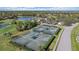 Well-maintained tennis courts near a lake, offering recreational opportunities and scenic views at 1975 White Feather Ln, Nokomis, FL 34275