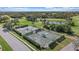 Aerial view of well-maintained tennis courts surrounded by lush greenery, perfect for recreation at 1975 White Feather Ln, Nokomis, FL 34275