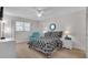 This cozy bedroom boasts natural light, a ceiling fan, and inviting furniture at 204 46Th Avenue W Ter # 412, Bradenton, FL 34207