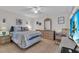 Bedroom with ceiling fan, laminate flooring and a comfortable queen bed at 204 46Th Avenue W Ter # 412, Bradenton, FL 34207