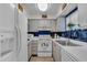 Galley kitchen featuring white appliances and ample storage at 204 46Th Avenue W Ter # 412, Bradenton, FL 34207