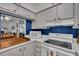 Kitchen featuring white cabinets and a white stove at 204 46Th Avenue W Ter # 412, Bradenton, FL 34207