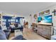Comfortable living room features a large television, coastal decor, and an eat-in kitchen at 204 46Th Avenue W Ter # 412, Bradenton, FL 34207