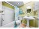 Bright bathroom with bathtub/shower, pedestal sink, and charming decor at 212 Pass Key Rd # 212, Sarasota, FL 34242
