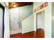 Bright foyer featuring wood floors, a door to the outside, and a second door leading to a closet at 212 Pass Key Rd # 212, Sarasota, FL 34242