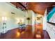 Open living room with soaring wood ceilings, stylish decor, gleaming floors, and a flatscreen television at 212 Pass Key Rd # 212, Sarasota, FL 34242