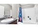Clean bathroom with a shower-tub combo and vanity with solid surface countertop at 2302 Manheim Ave, North Port, FL 34286