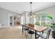 Bright dining room featuring tile floors, industrial light fixture, and modern decor at 2457 Appaloosa Cir, Sarasota, FL 34240