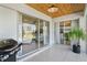 Covered patio with sliding glass doors offering views of the backyard and the interior spaces at 2457 Appaloosa Cir, Sarasota, FL 34240