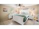 Bright bedroom featuring tiled flooring, a ceiling fan, and beach-themed decor for a tranquil ambiance at 2620 White Sands Dr, Sarasota, FL 34231
