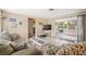 Comfortable living room with tile floors, neutral walls, access to a screened patio, and stylish furniture at 2620 White Sands Dr, Sarasota, FL 34231