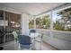 Enclosed patio featuring a dining table with seating and views of the private backyard; ideal for gatherings at 2620 White Sands Dr, Sarasota, FL 34231