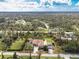 Aerial view of property featuring mature trees, pool and surrounding neighborhood at 2629 Rolling Rd, North Port, FL 34288