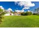 Expansive backyard featuring lush lawn, storage shed and beautiful landscaping at 2629 Rolling Rd, North Port, FL 34288