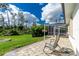 Paver patio and spacious backyard area with screened-in lanai in the distance at 2629 Rolling Rd, North Port, FL 34288