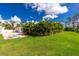 Spacious backyard, lush lawn and beautiful landscaping provide privacy at 2629 Rolling Rd, North Port, FL 34288